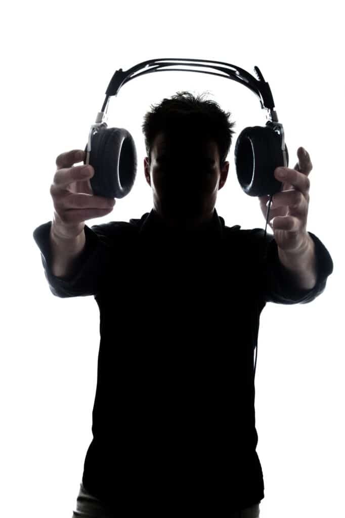 Male in silhouette showing headphones